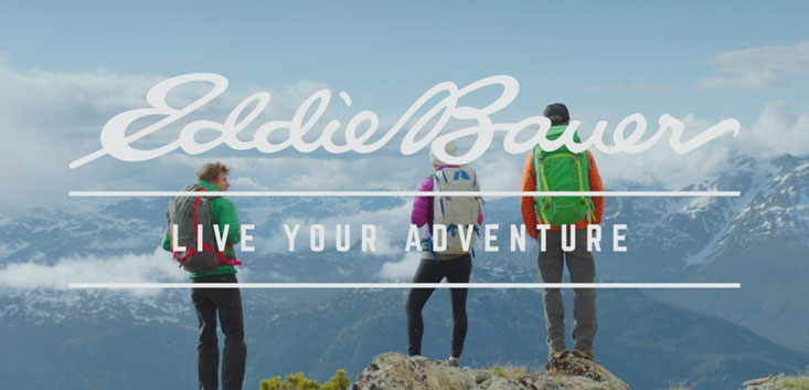 Merch Outfitters - Example Image of Branded Corporate Goods & Branding Items - Eddie Bauer logo and 3 people atop mountain with backpacks