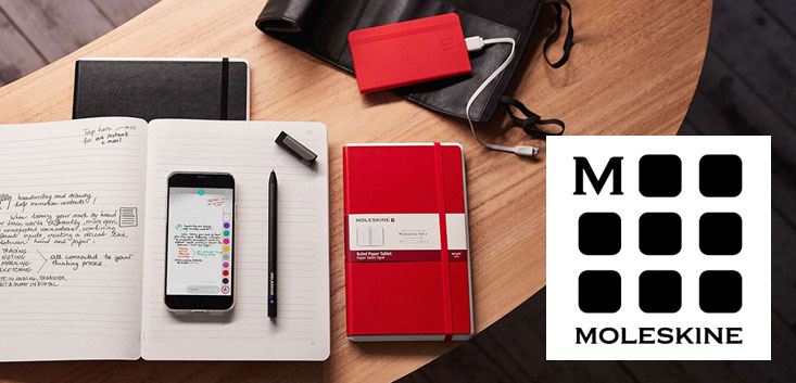 Merch Outfitters - Example Image of Branded Corporate Goods & Branding Items - Moleskine logo and desk with journals