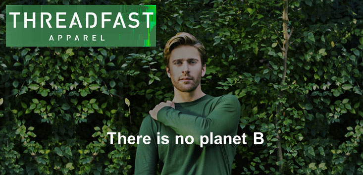Merch Outfitters - Example Image of Branded Corporate Goods & Branding Items - Threadfast Apparel logo and man wearing long sleeve tee in front of green leaves